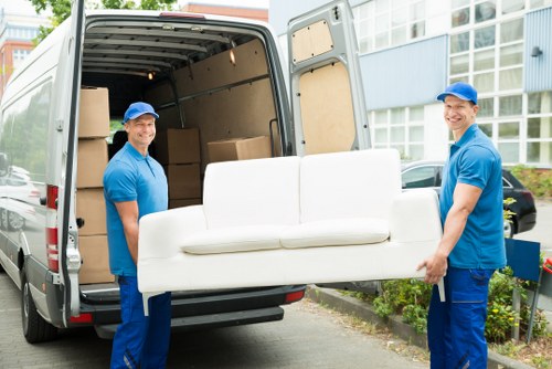 Man and van crew loading household items for transport
