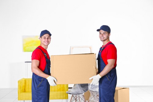 Local moving team arranging unpacking tasks in a Kennington property