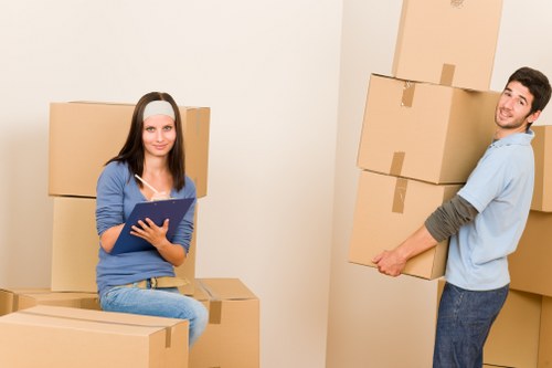 Moving team managing bulky furniture in a Kennington street